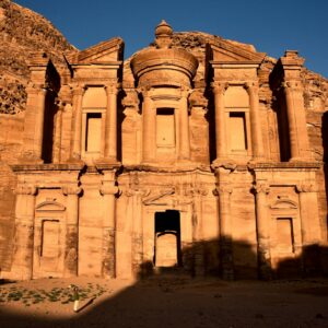 a large stone building in the middle of a desert